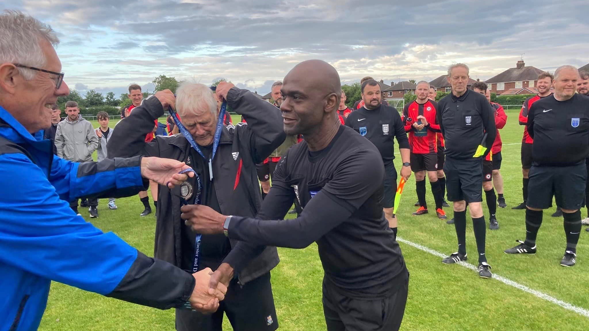 A Chester referee being presented with recognition in front of the local community