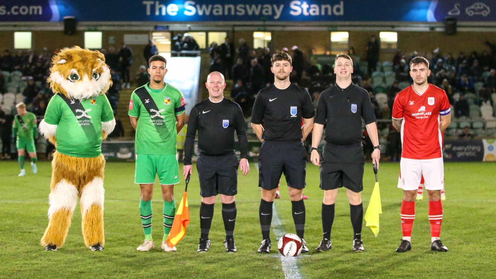 Referees and assistant referees pictured with teams before kick-off